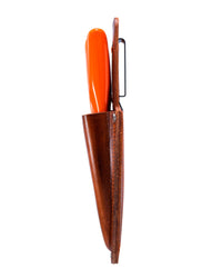 Leather secateur sheath with orange secateurs on a while background photographed from the side