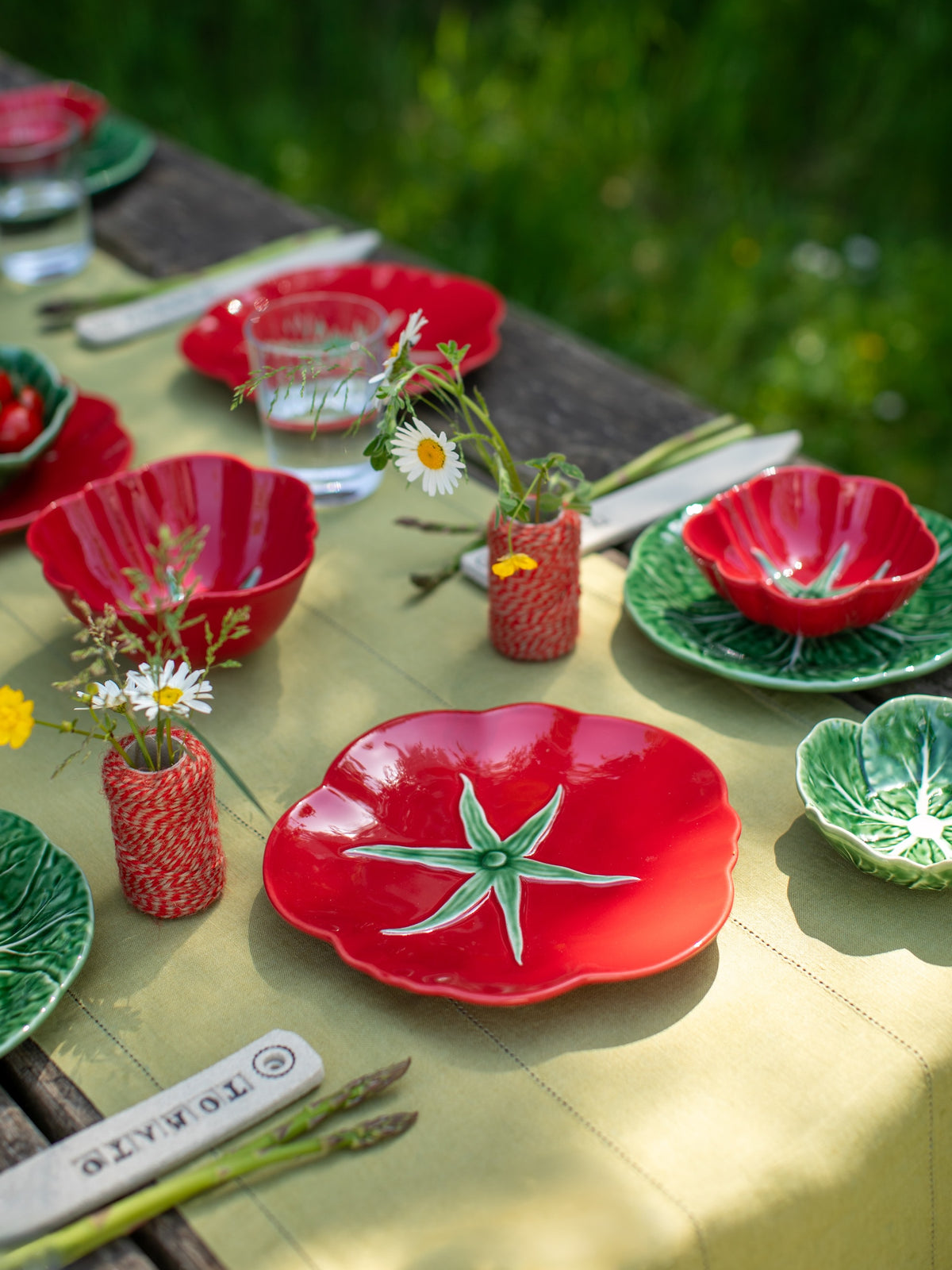 Colorful ceramic plates and vases on a table outdoors
