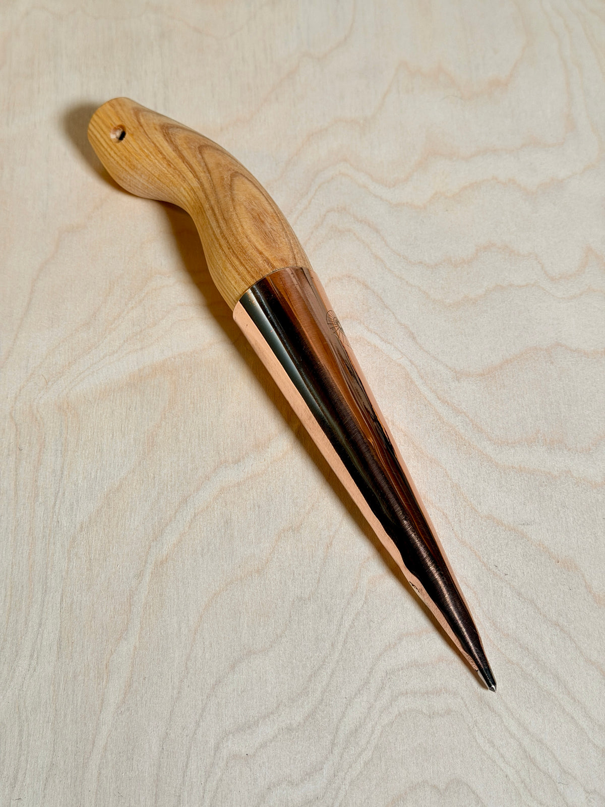 Copper dibber on birch ply background