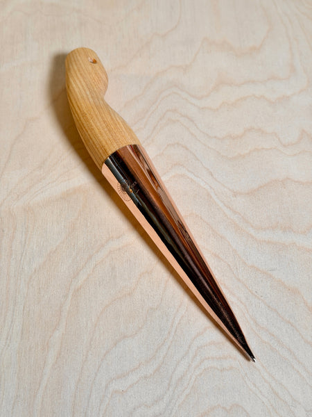copper dibber for planting on birch ply background