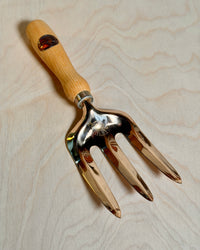 Bronze fork on a birch ply background