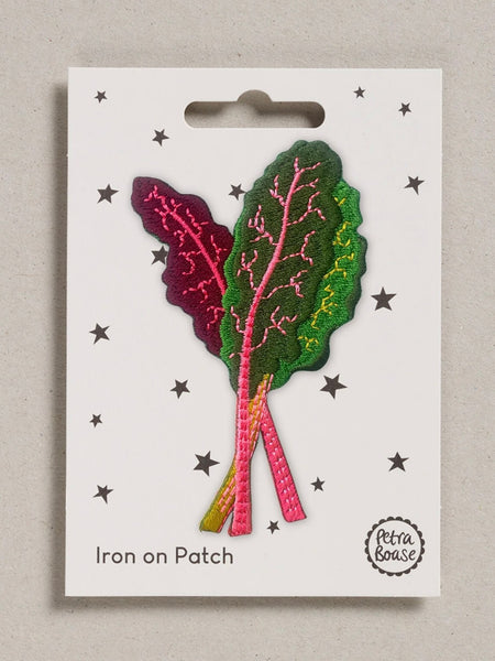 Iron-on patch of multi-coloured leafy greens on a white card with star patterns