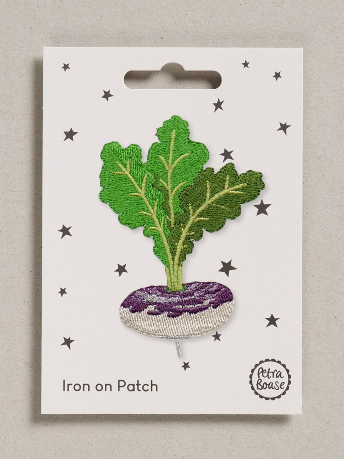 Iron-on patch of a leafy purple and grey turnip on a white card with star patterns