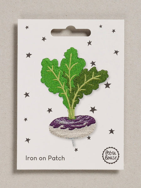 Iron-on patch of a leafy purple and grey turnip on a white card with star patterns