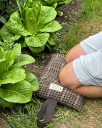 Garden kneeler being used in a vegetable garden with lettuce